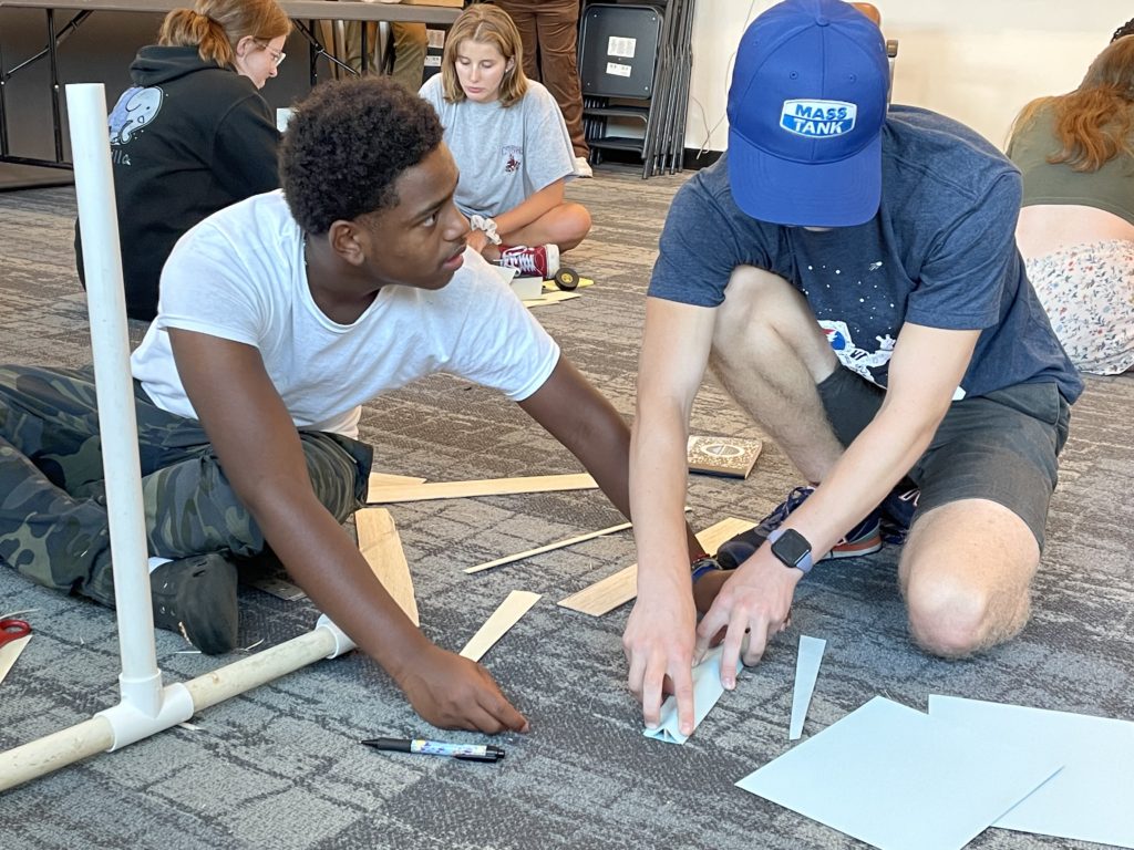 Two 2022 participants work on their concept for a floating wind turbine